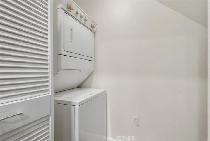 In-unit laundry closet with stacked washer and dryer