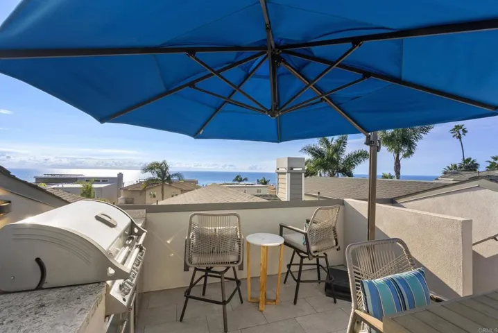 Lounging area, grill, refrigerator and sink located on this level