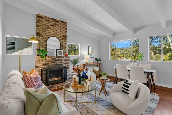 Living room with wood finished floors and a fireplace