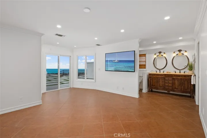 Primary #2 bedroom downstairs with sliding glass doors to backyard