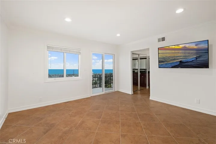 Upstairs Primary bedroom with balcony and grand Ocean Views!