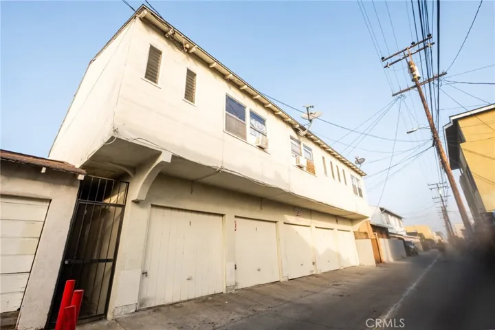 View of the back of the building, showing 5 garages in alley way.