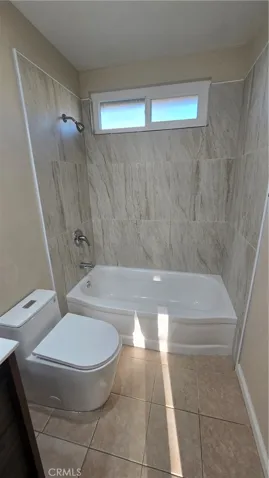 New bathroom, tiled bathtub wall, upgraded one piece toilet