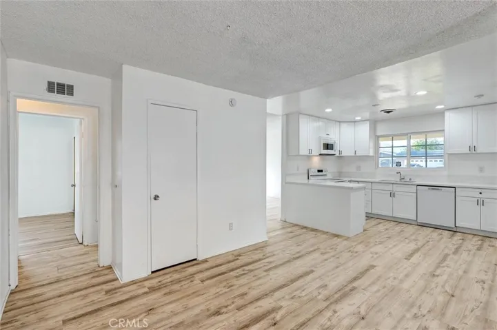 KITCHEN DINING AREA AND VIEW OF HALLWAY & 1ST BEDROOM