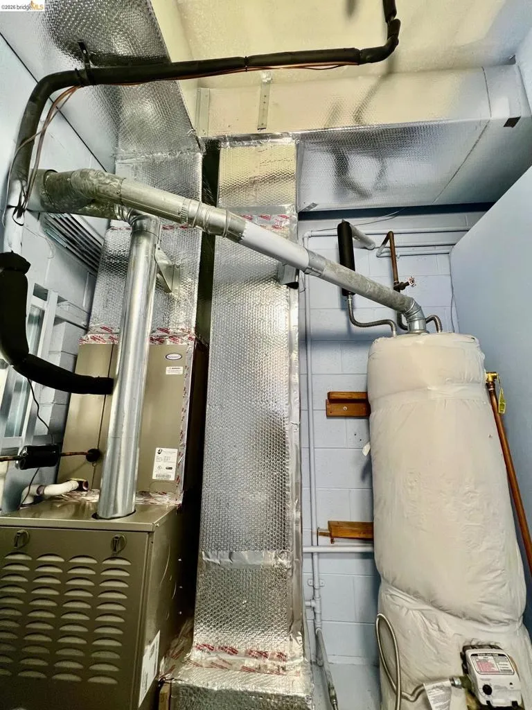 Utility room featuring heating unit