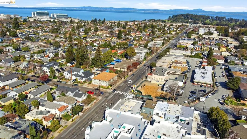 View of property location with a water and mountain view and nearby suburban area