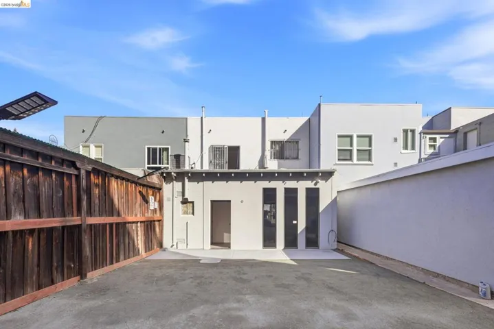 Back of property with stucco siding and a patio