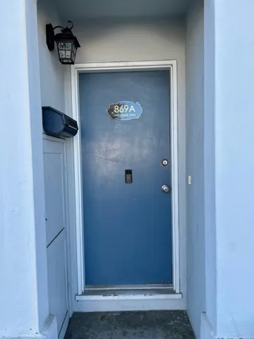 Entrance to property featuring stucco siding