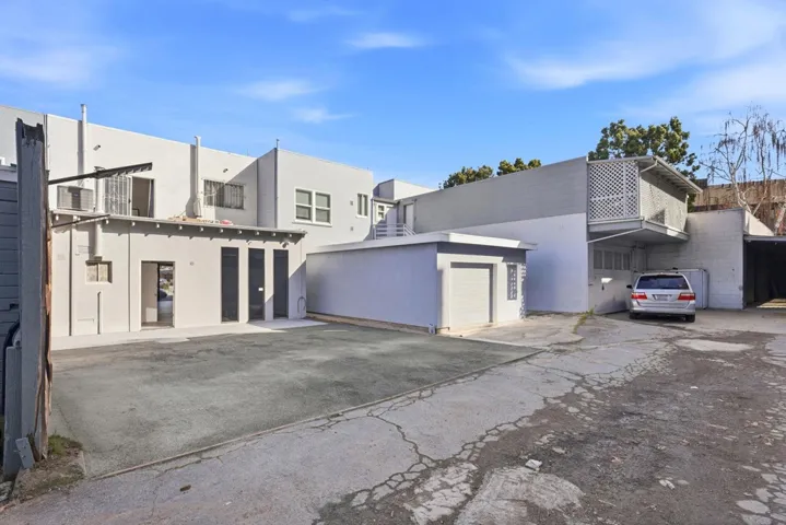 Back of house featuring stucco siding and a garage