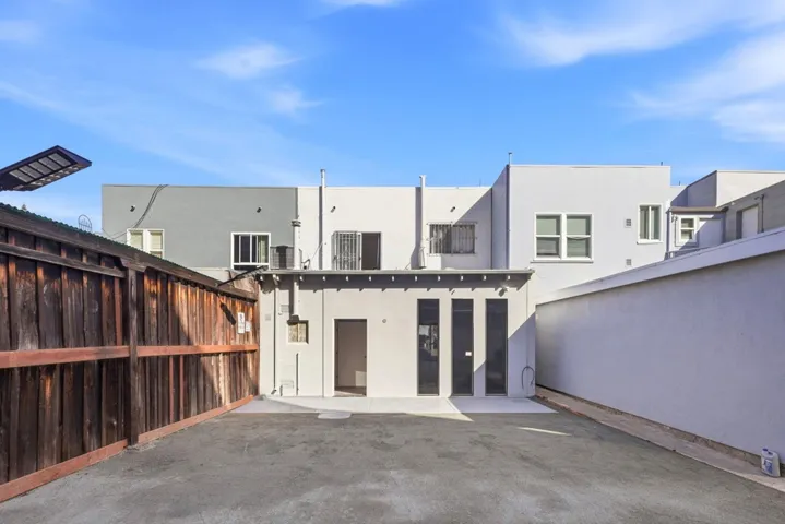 Back of property with stucco siding and a patio