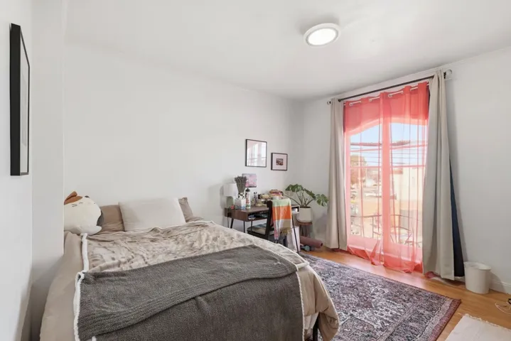 Bedroom featuring light wood-style flooring and crown molding