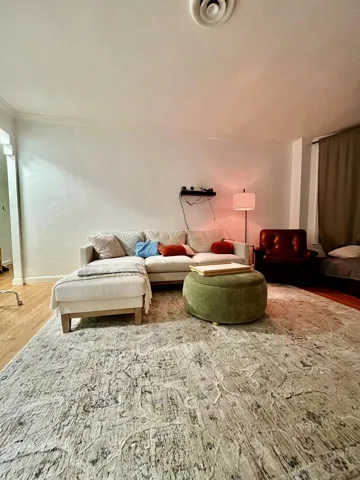 Living area with wood finished floors and baseboards
