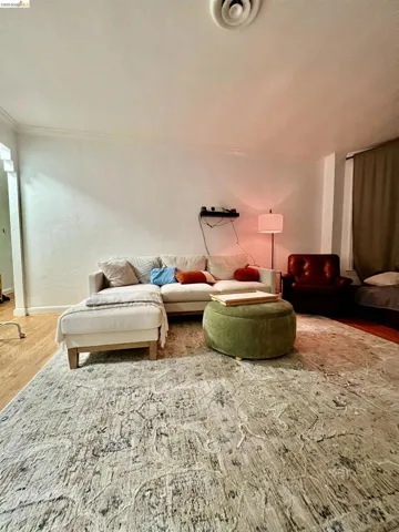 Living area with wood finished floors and baseboards