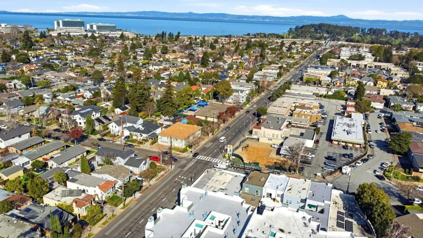 View of property location with a water and mountain view and nearby suburban area