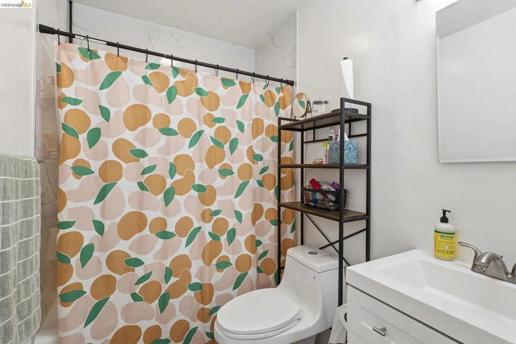 Bathroom featuring a shower with curtain and vanity