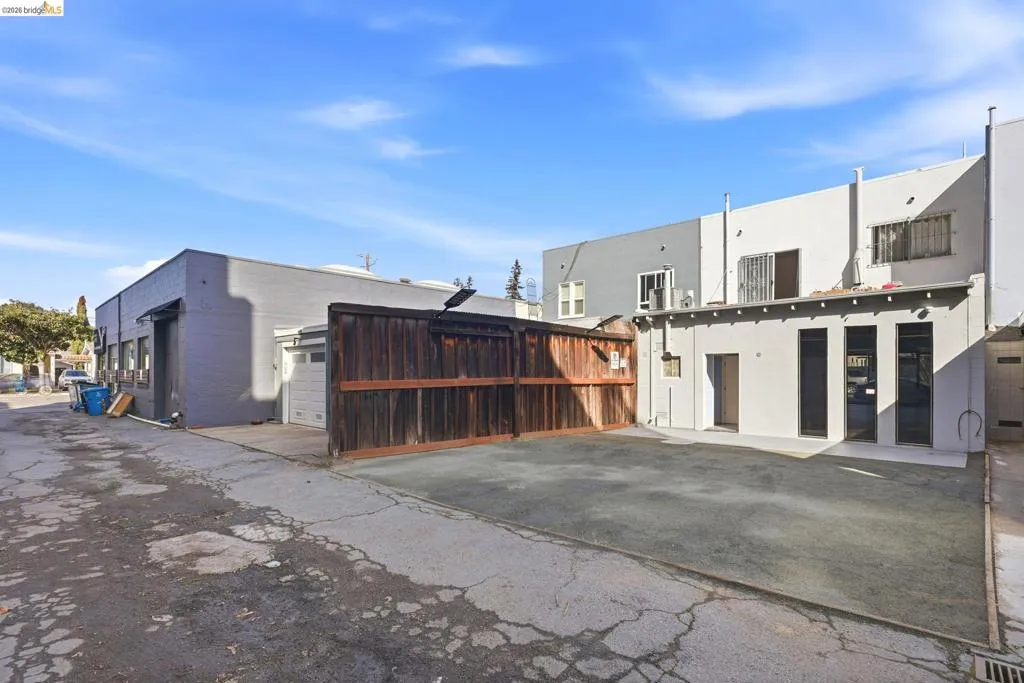 Rear view of property featuring stucco siding and a garage