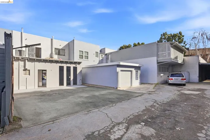 Back of house featuring stucco siding and a garage