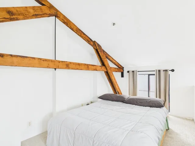 Carpeted bedroom with lofted ceiling