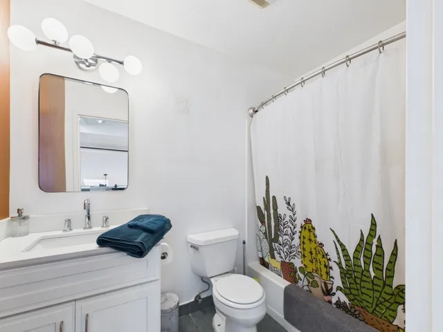 Bathroom with vanity and shower / bath combo