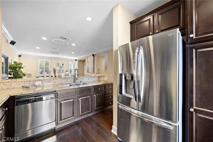stainless double sinks, and stainless appliances including a gas range, dishwasher, and microwave