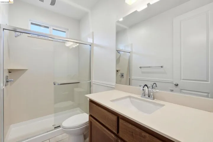 Bathroom featuring a stall shower and vanity