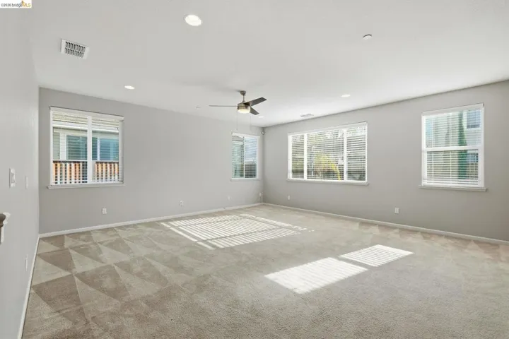 Unfurnished room with carpet floors, a ceiling fan, and recessed lighting