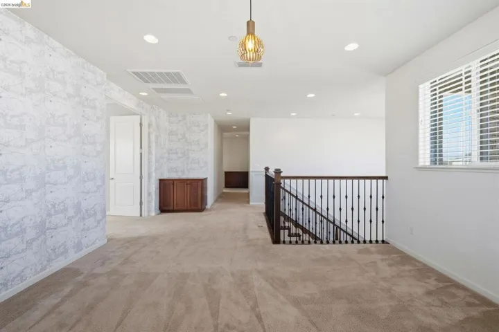 Spare room with light colored carpet, recessed lighting, and wallpapered walls
