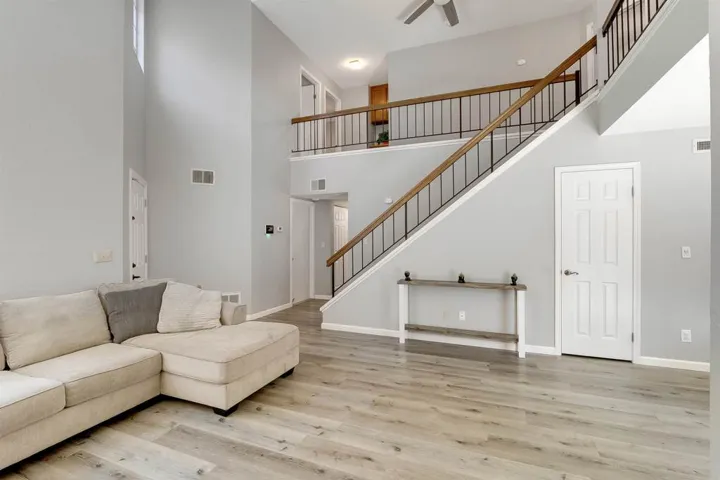 Living room with a towering ceiling and light wood finished floors