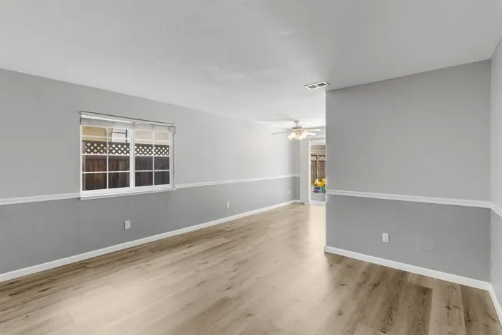 Spare room with baseboards and light wood-style floors