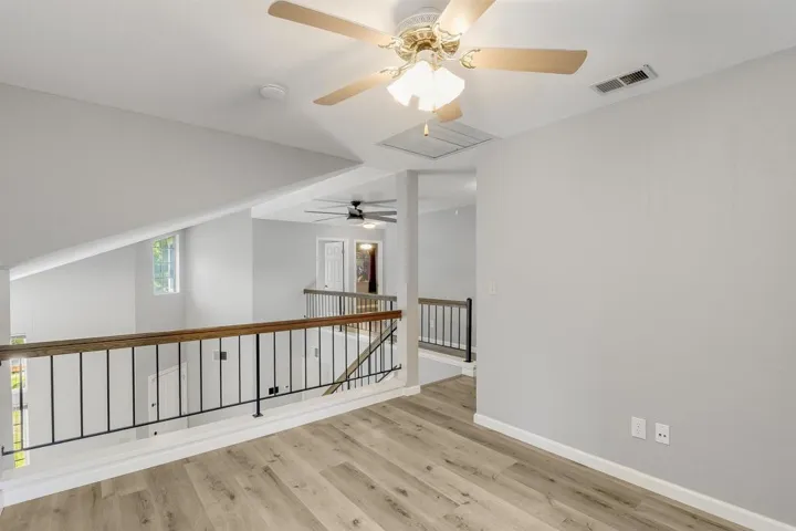Unfurnished room with light wood-type flooring and a ceiling fan