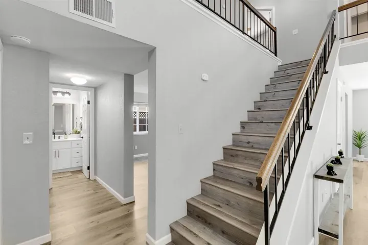 Stairway featuring baseboards and wood finished floors