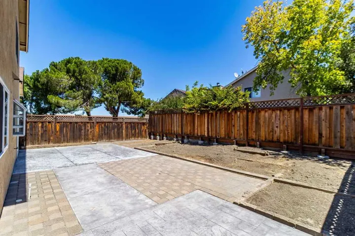 Fenced backyard with a patio area