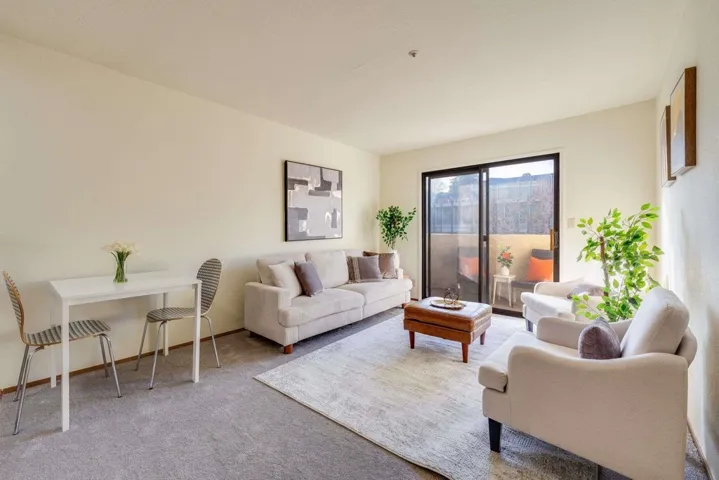 Living area featuring carpet and baseboards