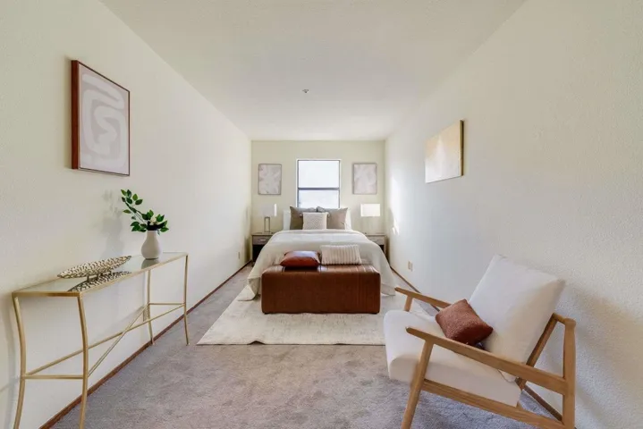 Bedroom featuring carpet floors and a textured wall