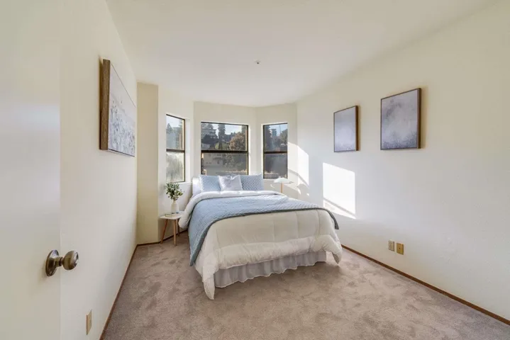 Bedroom featuring carpet floors and a textured wall
