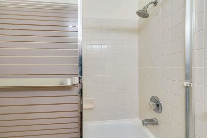 Full bathroom featuring shower / bath combination with glass door