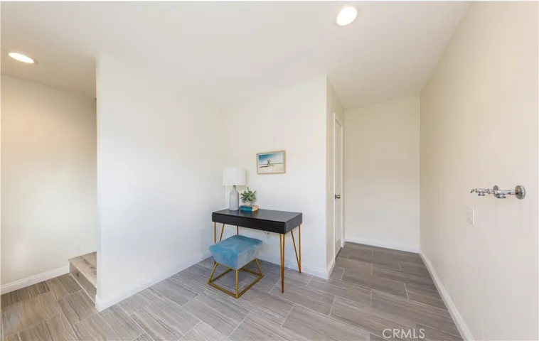 ADU entrance. Hall area with laundry station for washer/dryer and a closet for supply storage. Stairs going up to the 2nd floor.