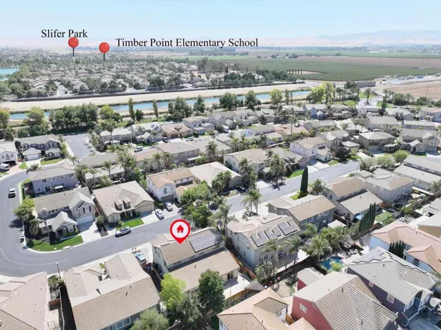 Aerial perspective of suburban area featuring a large body of water