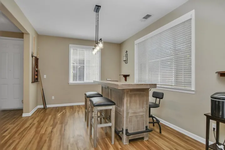 Dining room featuring light wood-style floors and a dry bar