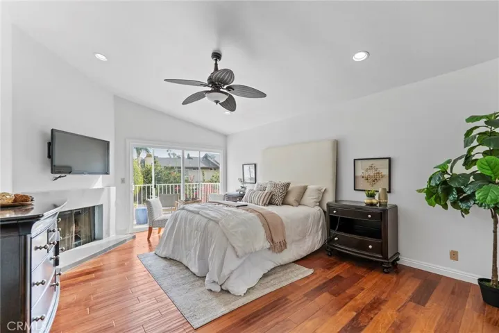 Primary Bedroom with fireplace and balcony