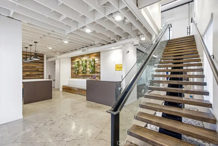 Grand staircase with open risers leading to a bright, airy second level.