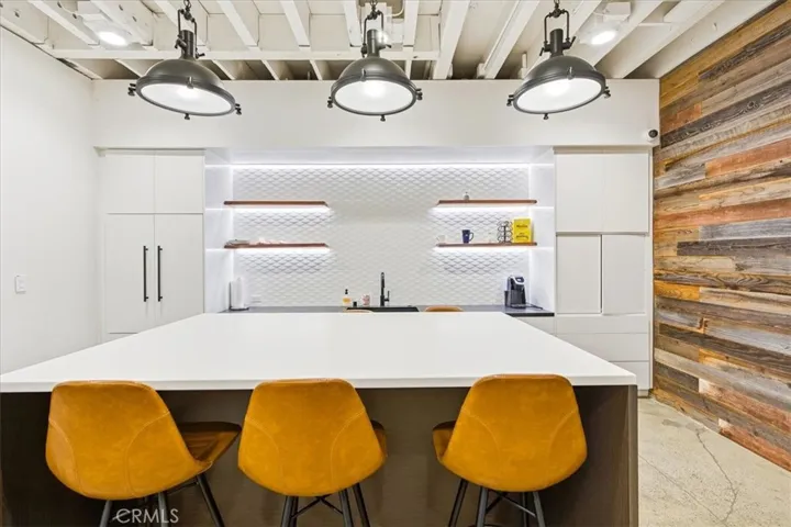 Gourmet kitchen with a striking island, pendant lighting, and functional design.