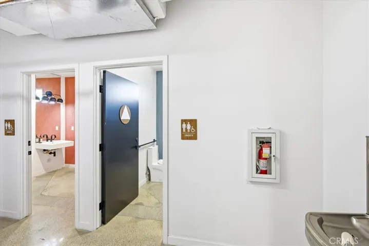 Hallway leading to a sleek, modern office space with contemporary finishes.