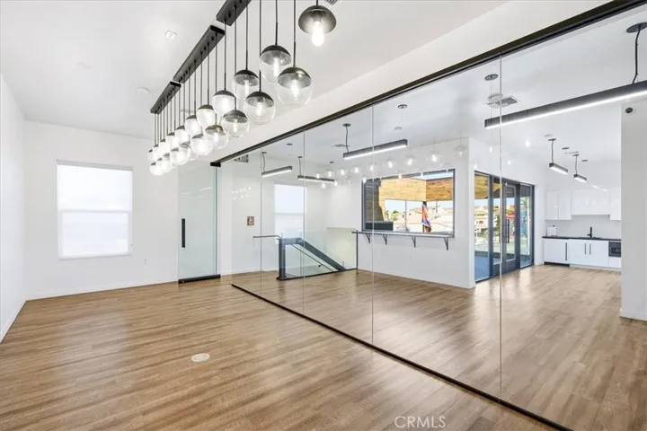 Spacious, open area with modern track lighting, perfect for a gallery or office.