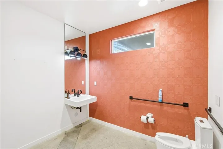 Sleek, contemporary bathroom with vibrant accents and high-end fixtures.