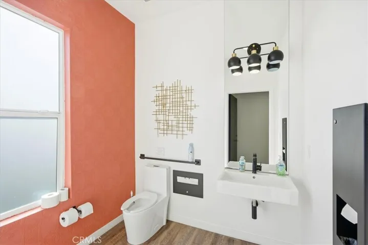 Bright and modern bathroom with a statement wall and sleek fixtures.