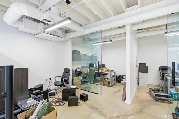 Bright and airy open-plan space with high ceilings and expansive windows.