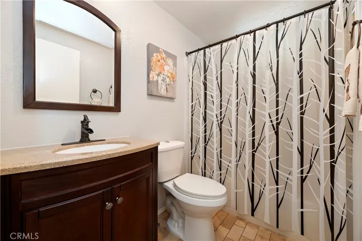 Guest Bathroom with tub/shower combo and tile floors