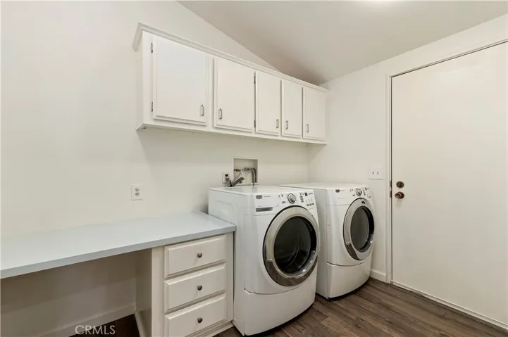 Laundry room with desk and cupboards. There is a pantry behind the door not seen in​​‌​​​​‌​​‌‌​​‌​​​‌‌​​​‌​​‌‌​​‌‌​​‌‌​​​​ Photo.