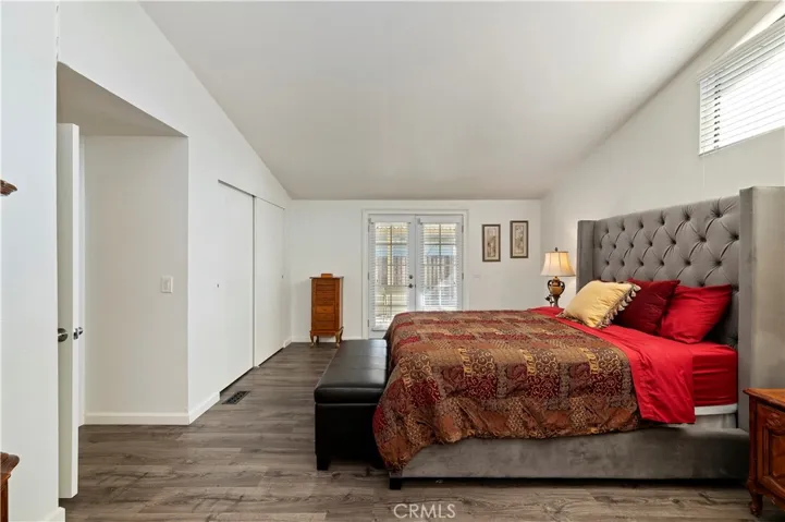 Primary Bedroom with French Doors to backyard. Closet is a walk-in!